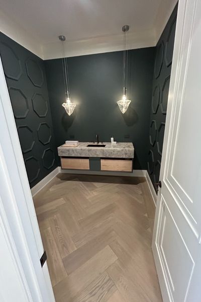 Dedham MA bathroom remodel installation with wood floors and dark accent wall